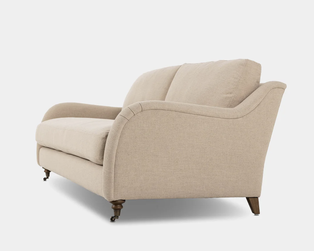 Curved upholstered sofa, photographed on white.